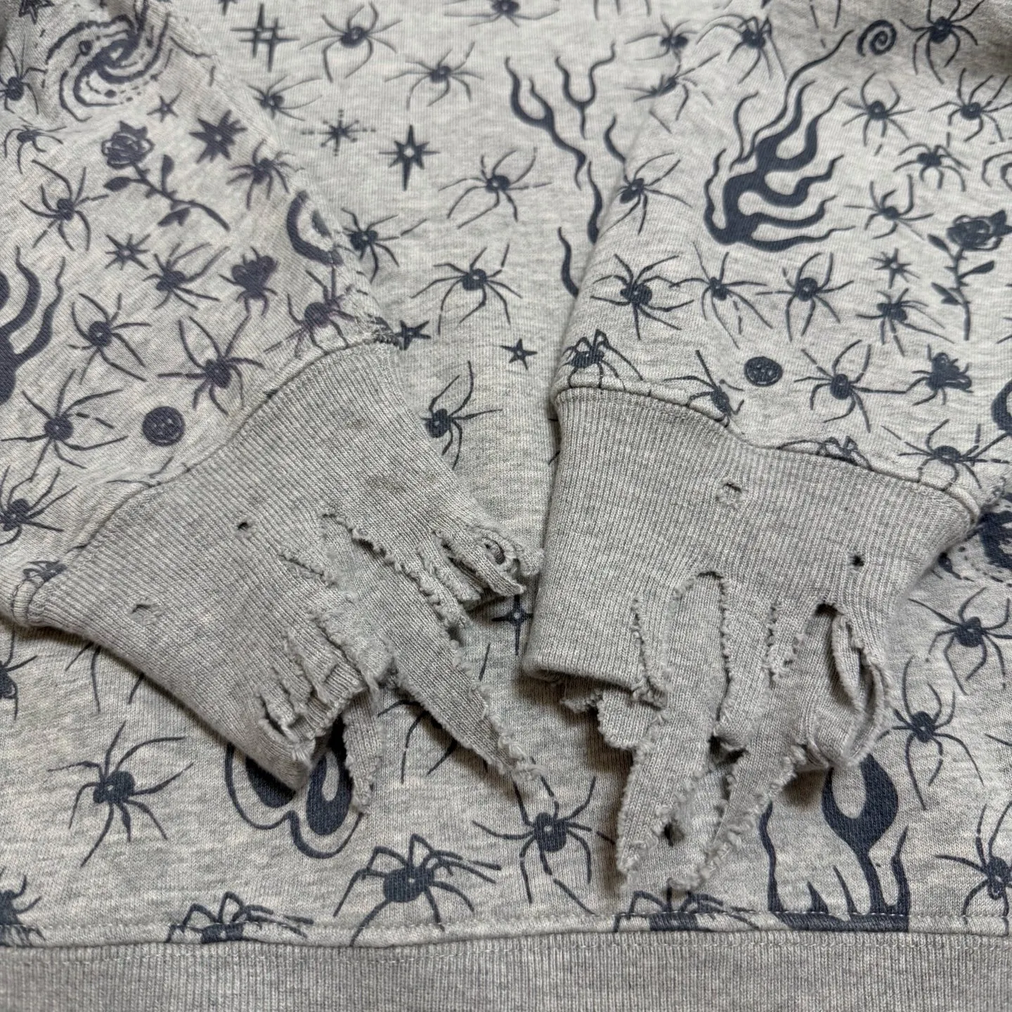 More accessories details SAINT Mxxxxxx x DR. WOO HOODIE ' Dr.Woo ' /GRY Flame Swirl Spider Web Hoodie Distressed Gray S-XL Custom-woven and dyed nostalgic gray fabric. After printing, the garment is sprayed with potion to make the fabric oxidize and fade, plus a large number of artificial fabric destruction processes, making the whole piece of clothing look old and unique as a work of art. This hoodie is co-branded with a famous tattoo design artist. A full set of Dr.Woo accessories has been customized. Bringing you authentic items!